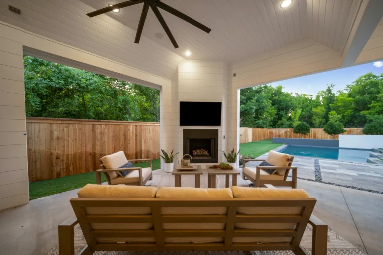 Back patio with seeting and tv with white ceiling and walls 1