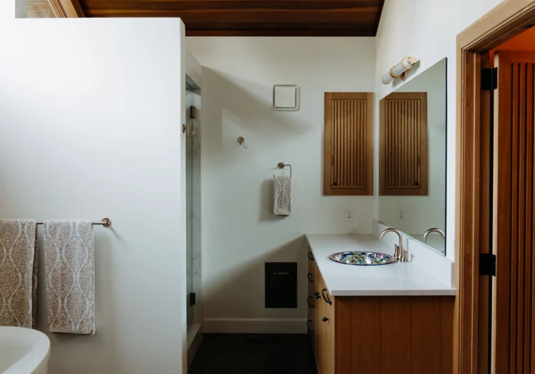 Bathroom with sink and white painted walls with wood design all around 1