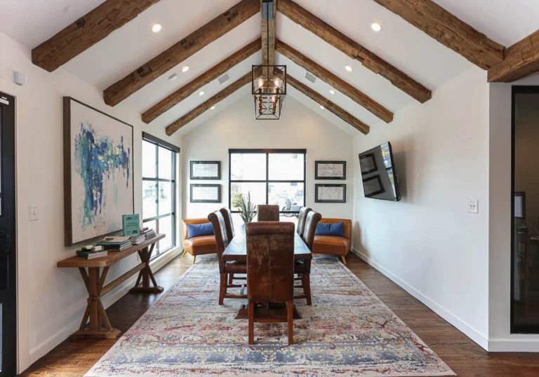Dining room with wood and white design, rug and natural lighting coming in through window 1