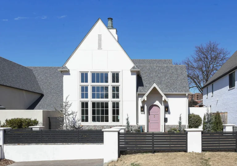 White painted house exterior with gate and front lawn with garden 1
